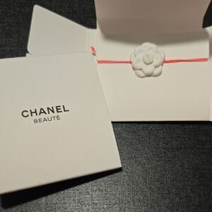 New in box never used CHANEL camellia white flower on pink string Ajujustable